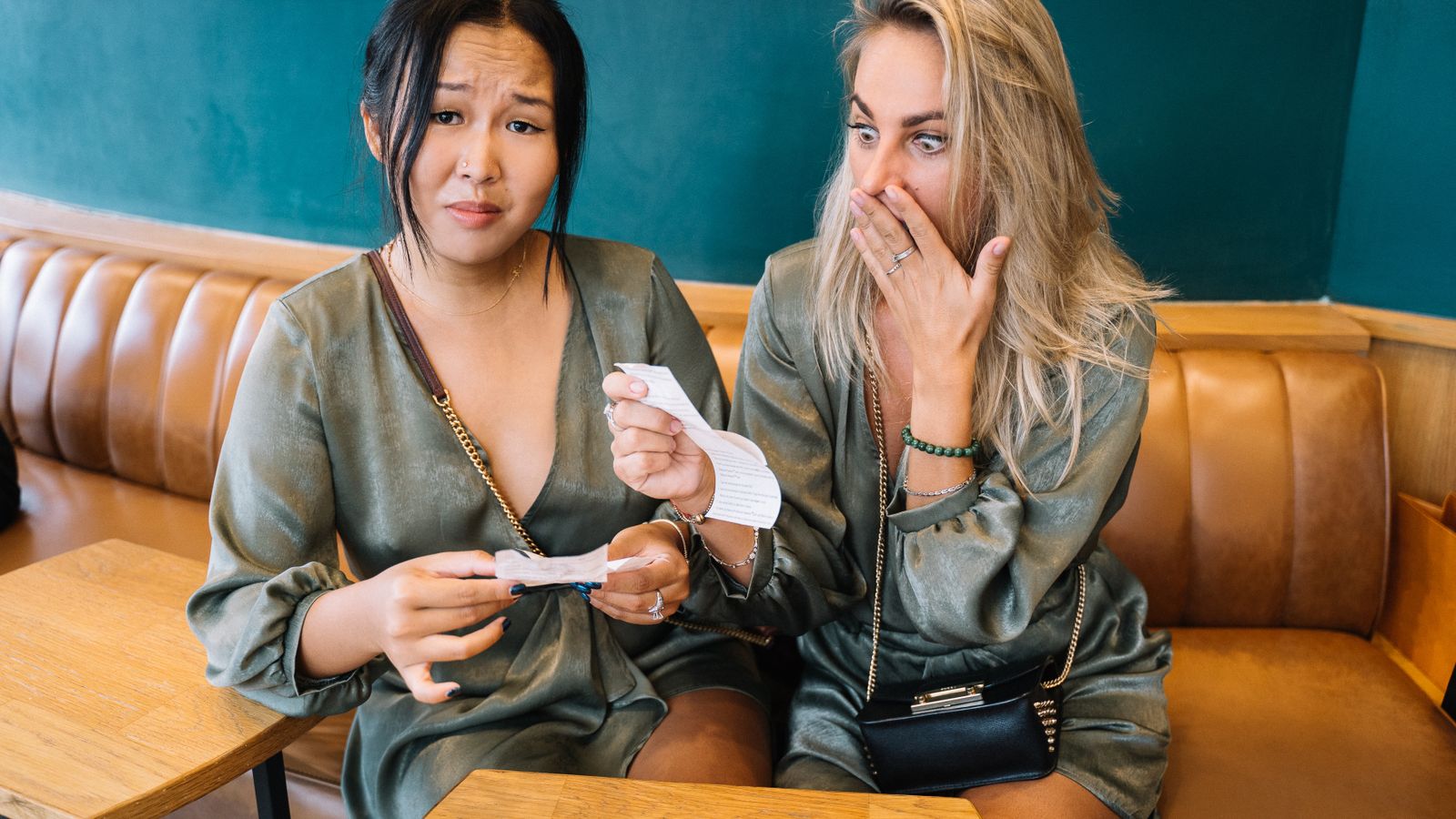 Two friends looking at a restaurant bill